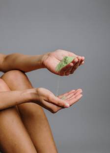 Left hand pouring sand on the right hand