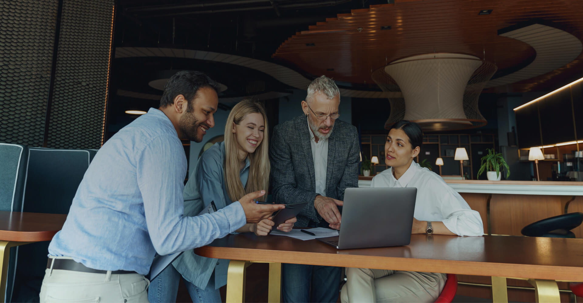Group colleagues gathered around computer