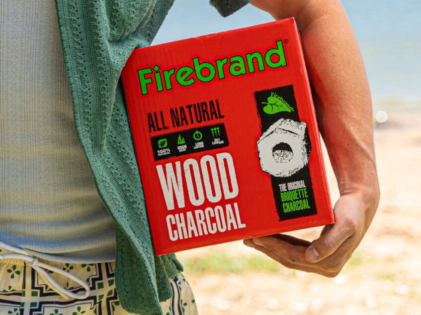 Firebrand All Natural Wood Charcoal Box held by a man