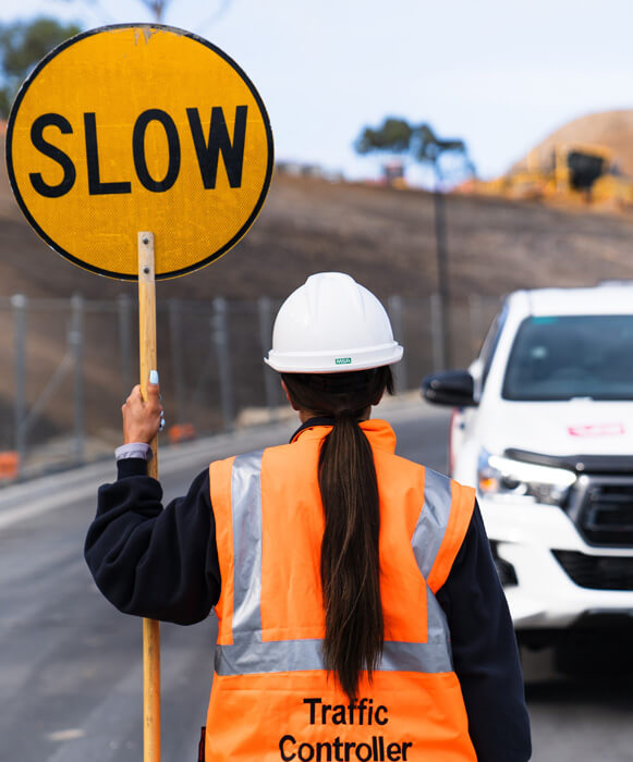 Manual laborer holding slow sign
