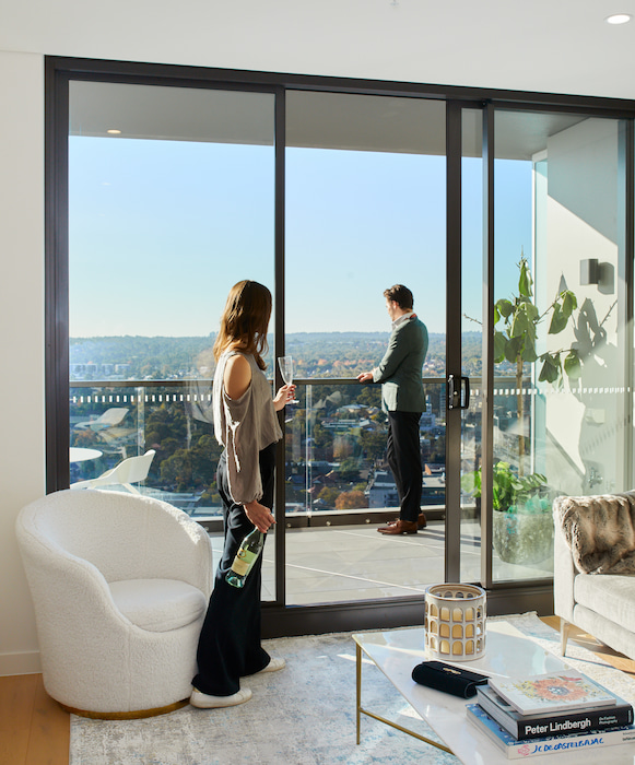 Perspective Buyer Viewing a Skyline from a Property Balcony | Marketing Solutions for Property Developers